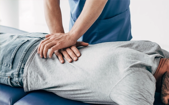Chiropractic Pasadena TX Back Adjustment HP A chiropractor delivering an adjustment to a patient's lower back